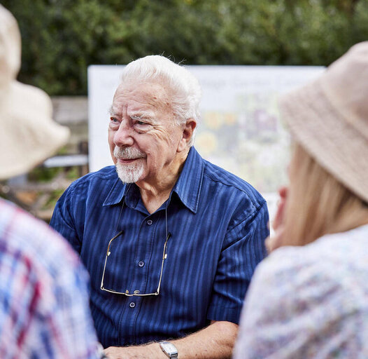 a man talking with a group of people