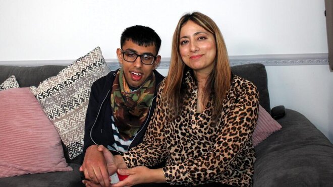 a woman with her son sat on sofa