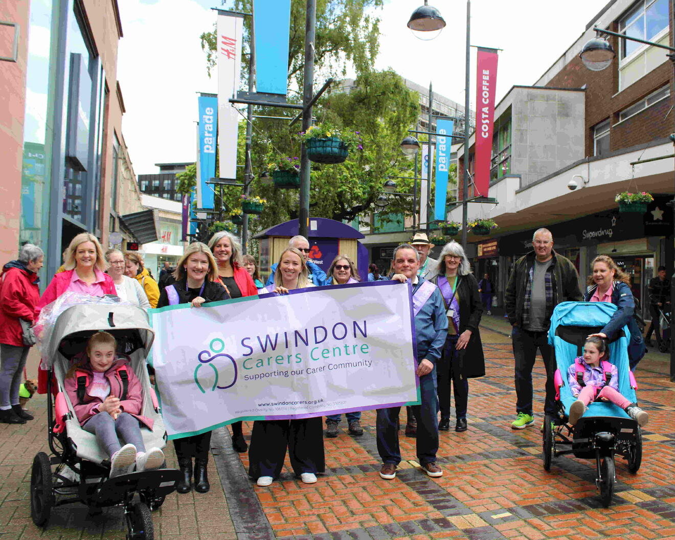 a group of people with a swindon carers centre banner