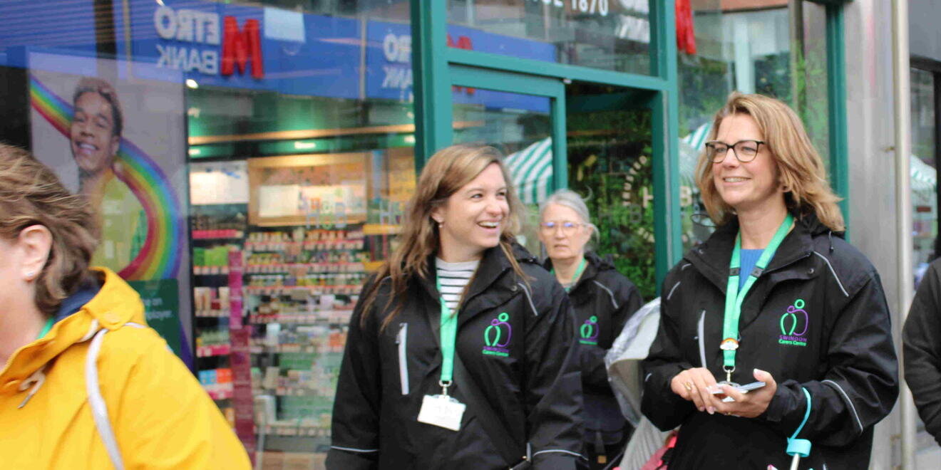 two women walking along street