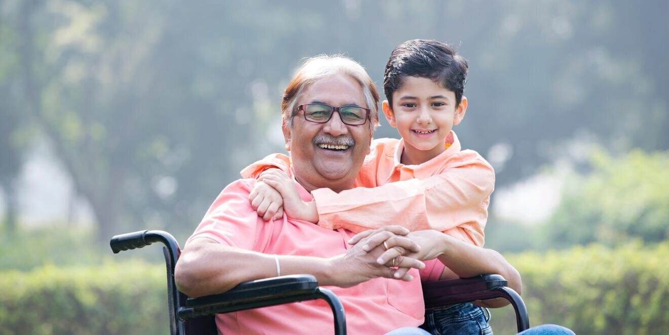 man in wheelchair with son